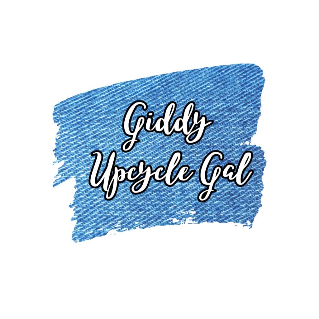 Giddy Upcycle Gal in script font, white with a black outline over a denim background that looks like it was revealed by two paint brush strokes.